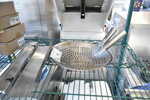Brand new metal skimmers with slight imperfections on a rack. Includes three items from auction. Condition: scratch and dent.