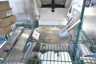 Brand new metal skimmers with slight imperfections on a rack. Includes three items from auction. Condition: scratch and dent.