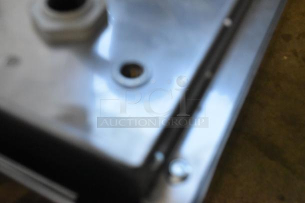 Blurred close-up of the Garland SH/WO 3500 stainless steel induction range showing surface details.