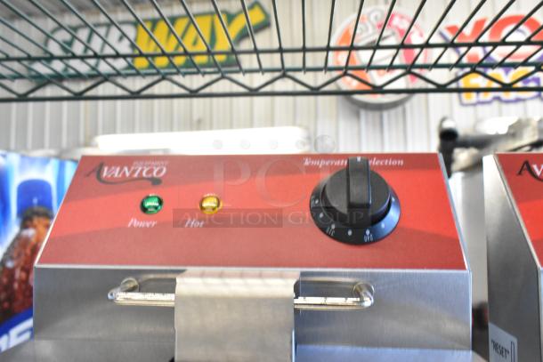 Avantco 177F102 stainless steel dual tank electric fryer, temperature dial visible, power and hot indicators lit.