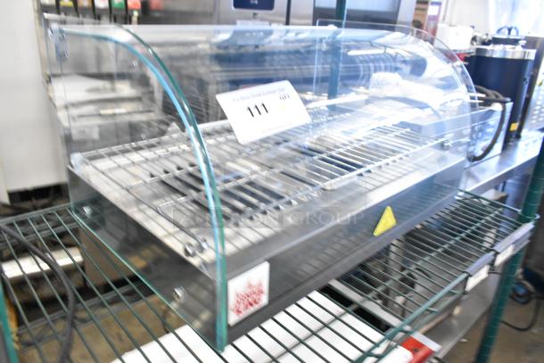 Brand new Carnival King 382HDCG1A silver curved glass hot food display case; 120V, 1 phase, with 1 shelf; slight cosmetic defects.