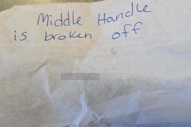 Handwritten note on paper, stating "Middle handle is broken off."