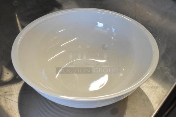 White poly bowl, unused, with smooth finish and slight reflective surface, part of a scratch and dent auction set.