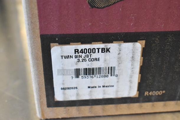 San Jamar R4000TBK Twin 9" Jumbo Tissue Dispenser, new scratch and dent, model info and barcode on label.