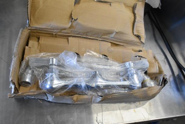 Cardboard box containing a T&S B-0024-H flexible hose and Assure 190FW812 swing spout faucet, both new with minor box wear.