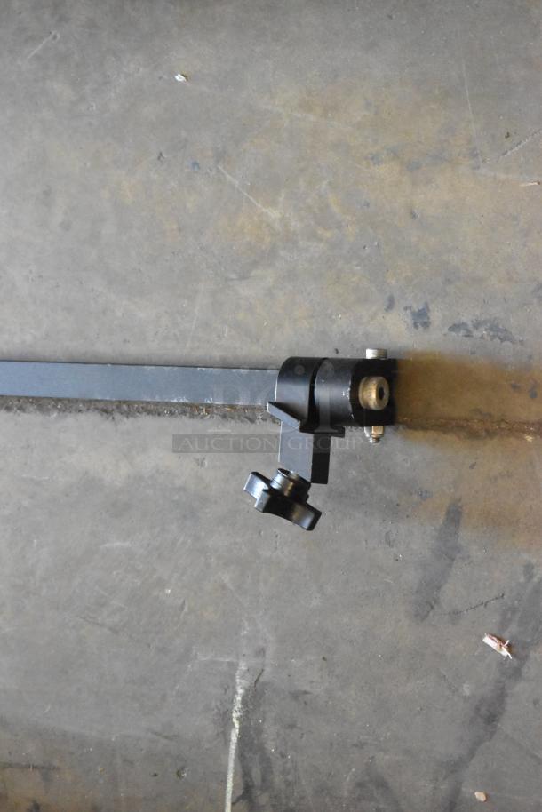 Black metal component with an adjustable knob, possibly part of a faucet handle set. Good condition, auctioned as part of a lot.