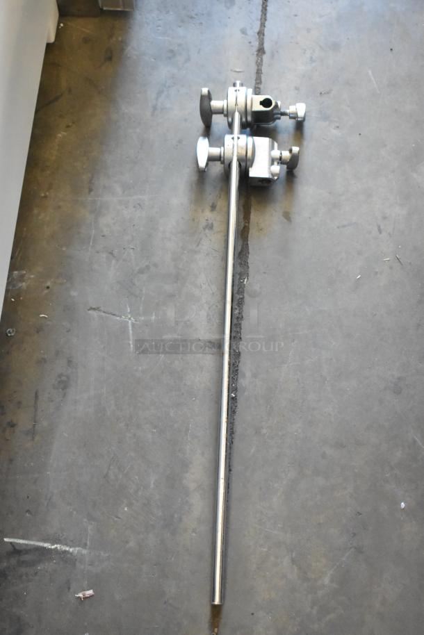 Four metal faucet handles and pieces, showing valves and attachments on concrete surface. Good condition.