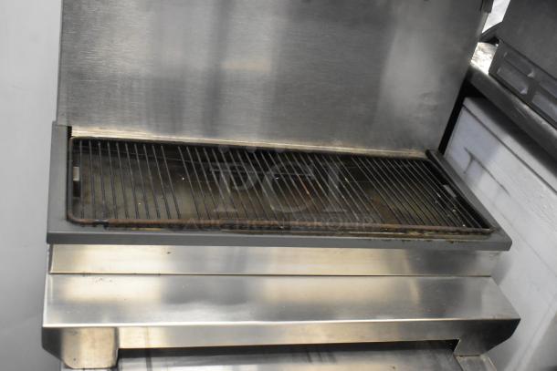 Stainless steel commercial beverage machine, 6 flavors, on ice bin. 115 volts, 1 phase. Good condition, ideal for businesses.