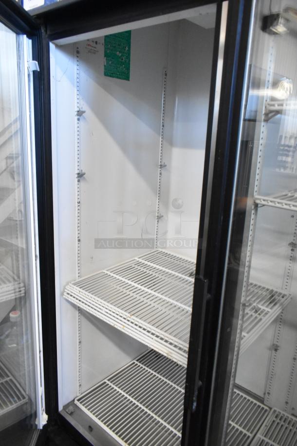 True GDM-72 commercial 3 door cooler with poly-coated racks, visible wear, 115V 1-phase, metal exterior.