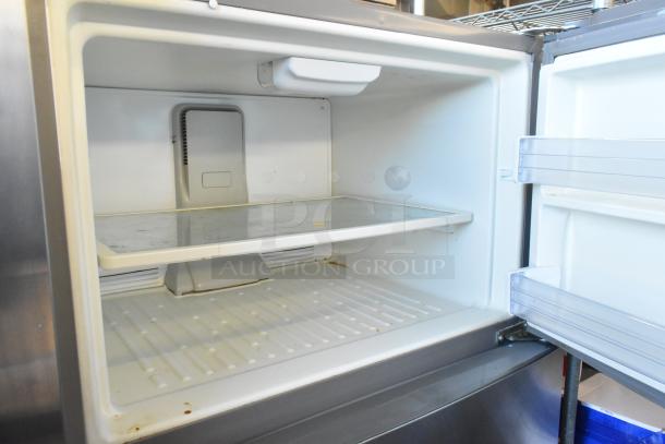 Whirlpool WRT511SZDM00 stainless steel cooler with freezer, 115 volts, interior view showing shelves and door storage.