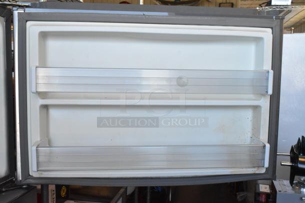 Whirlpool WRT511SZDM00 cooler door with shelves, stainless steel finish. Minor wear visible. 115V, 1 Phase.