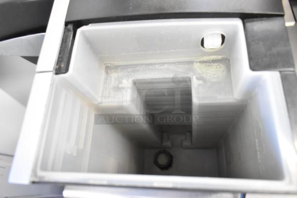 Keurig K150 coffee maker water reservoir interior, showing signs of wear. Suitable for single cup brewing.