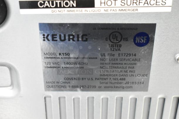 Keurig K150 coffee maker with label showing model, 120VAC, 1400W, 60Hz; commercial and household use; NSF listed.