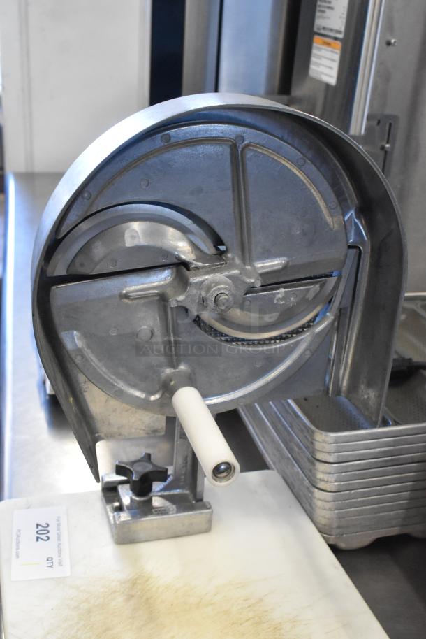 Nemco metal countertop vegetable slicer on mount, featuring a rotary blade. Appears in good condition, with mounting base.