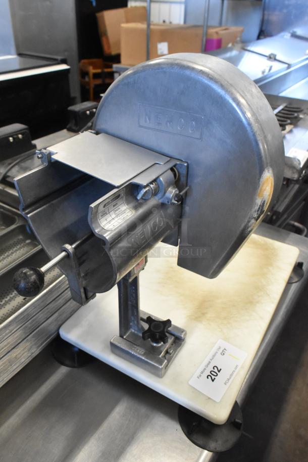Nemco metal countertop vegetable slicer on mount, sturdy construction, visible brand markings; essential for kitchen efficiency.
