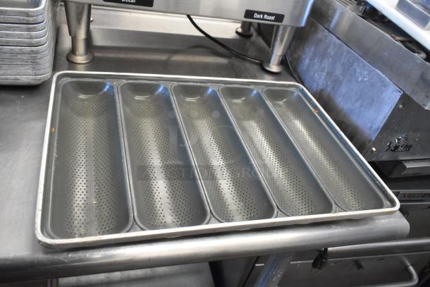 12 metal 5-loaf baking pans, vented design for even baking. Slight wear, ideal for professional baking use.