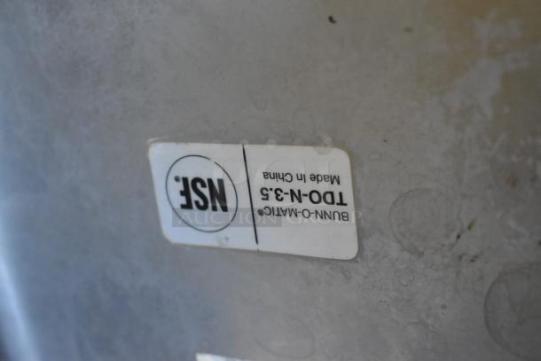 NSF label on Bunn TDO-N-3.5 iced tea dispenser, stainless steel, made in China, indicating safety standards.