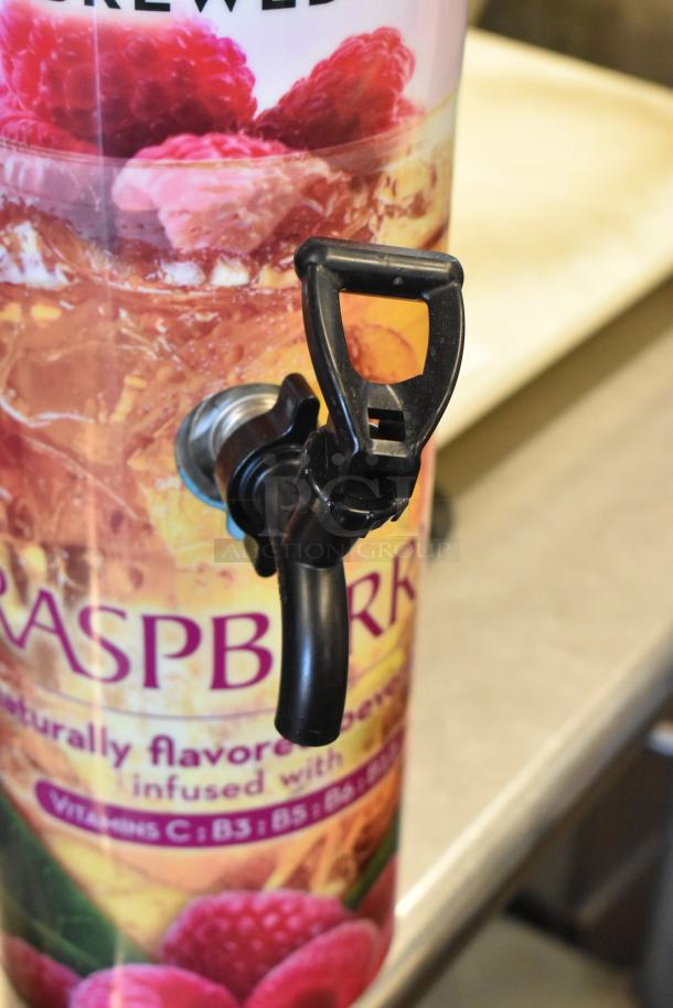 Three Bunn TDO-N-3.5 stainless steel iced tea dispensers, labeled with "Raspberry" flavored design, featuring plastic spouts.