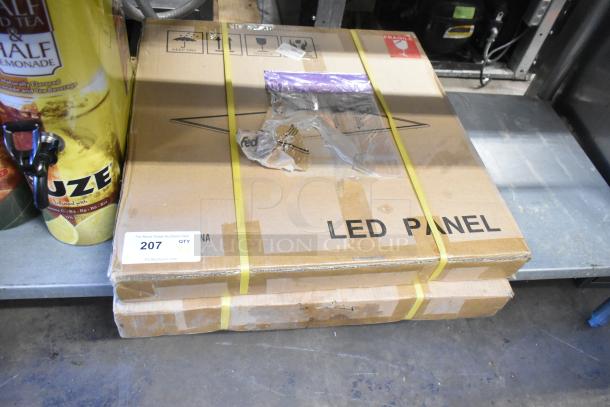 Two brand new LED panel lights in sealed boxes. Boxes marked "LED Panel" with auction label indicating quantity two.