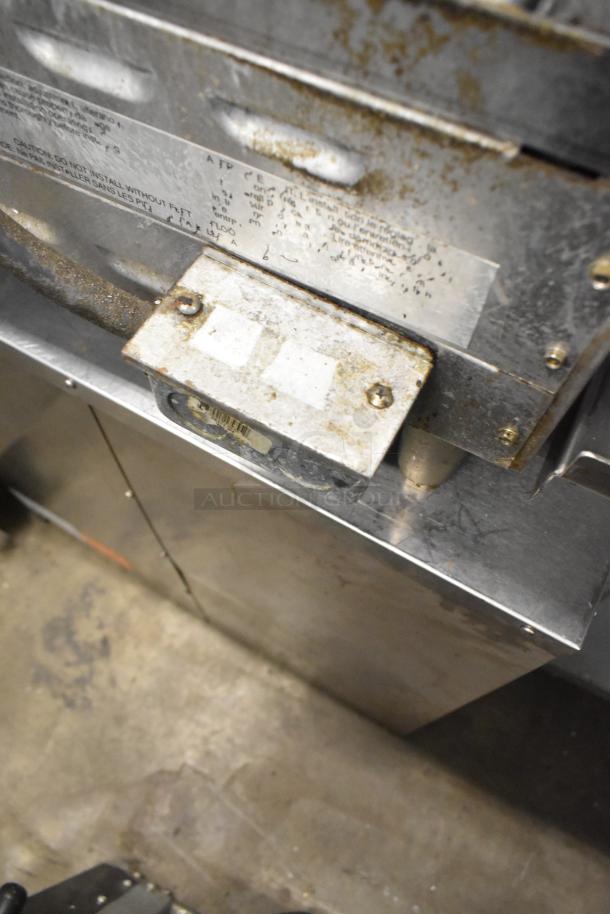 Star Max stainless steel commercial countertop grill showing wear, with visible labels and markings indicating model and usage instructions.