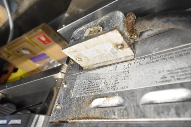 Star Max stainless steel commercial countertop grill, showing wear and rust. Labels present indicate model and safety info.