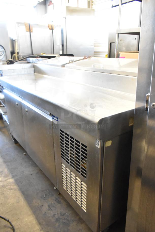 Stainless Steel Commercial Pizza Prep Table, on casters, 115V, 1 phase, with storage sections, in good condition.