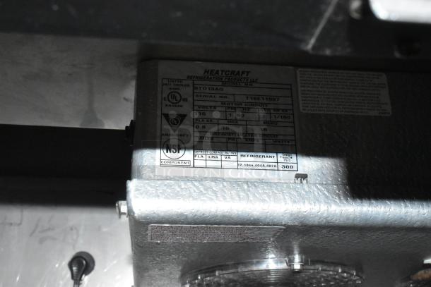 Stainless Steel Commercial Pizza Prep Table, 115V, 1 Phase, on casters. Heatcraft unit label with UL and NSF certification.