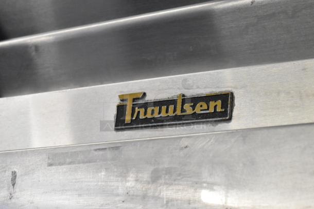 Traulsen RLT132WREHHS stainless steel commercial refrigerator, two half-size doors, on casters, logo visible, 115/208-230V.