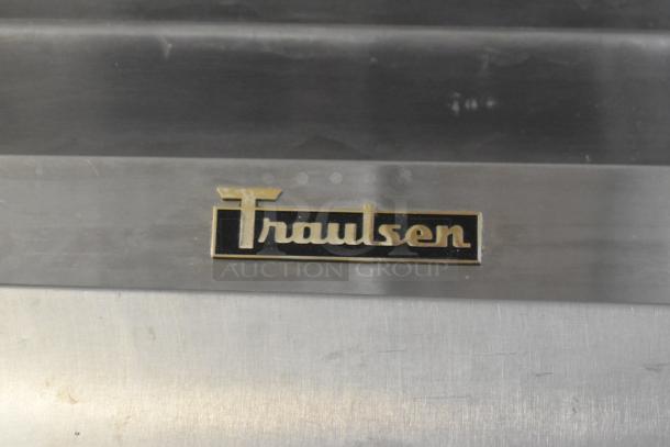 Traulsen RHT132WREHHS stainless steel commercial refrigerator, two half-size doors, visible logo, on casters, 115V, 1 phase.
