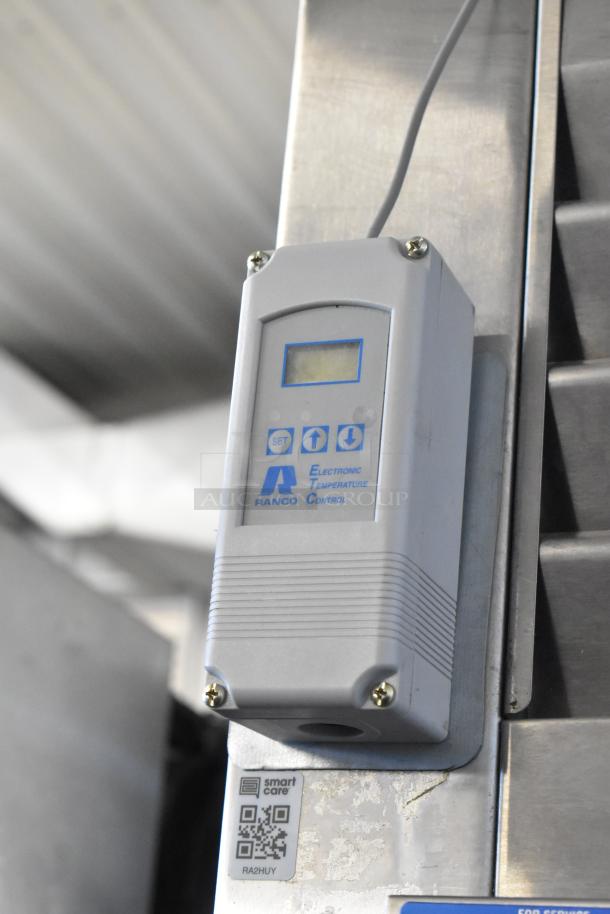 Electronic temperature control on Traulsen RHT132WREHHS stainless steel refrigerator, featuring digital display and Smart Care tag.