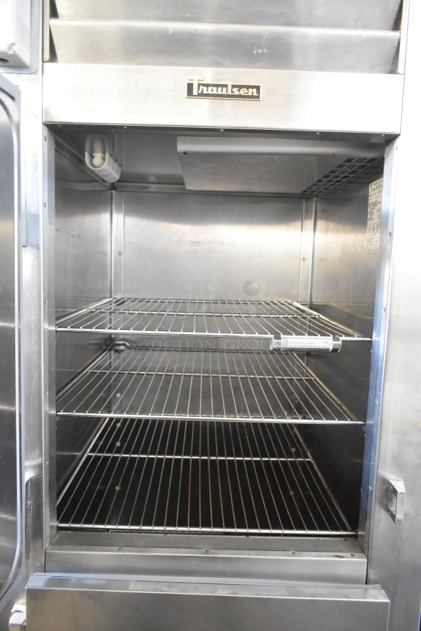 Traulsen RHT132WREHHS commercial refrigerator, stainless steel, half-size doors, interior shelving, on casters, 115V.