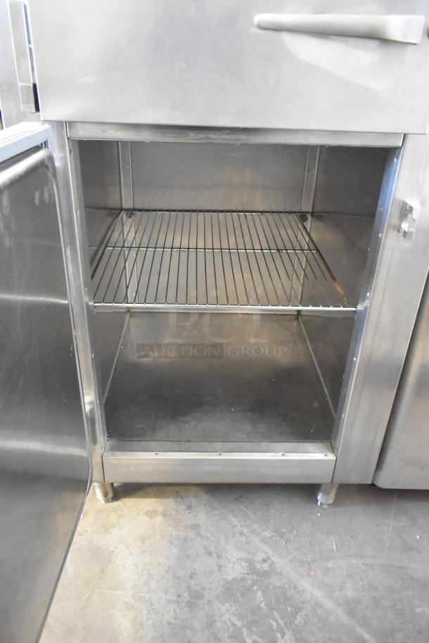 Traulsen RHT132WREHHS stainless steel reach-in refrigerator with two half-size doors and commercial casters, interior view.