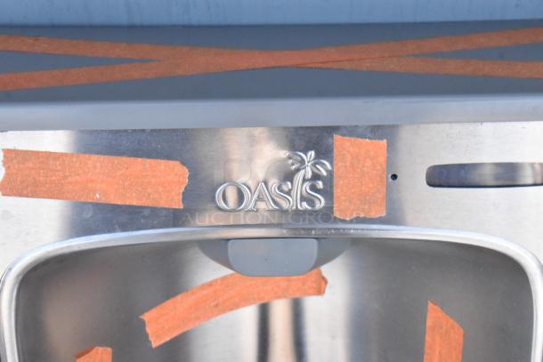 BRAND NEW Oasis PWEBF-005 stainless steel wall mount water fountain with orange tape markings, slightly scratched.