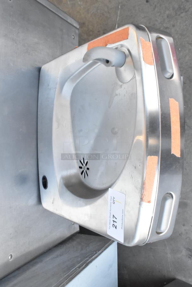 Stainless steel wall-mounted water fountain, Oasis PWEBF-005, new with visible scratches and dents, tagged "217" for auction.