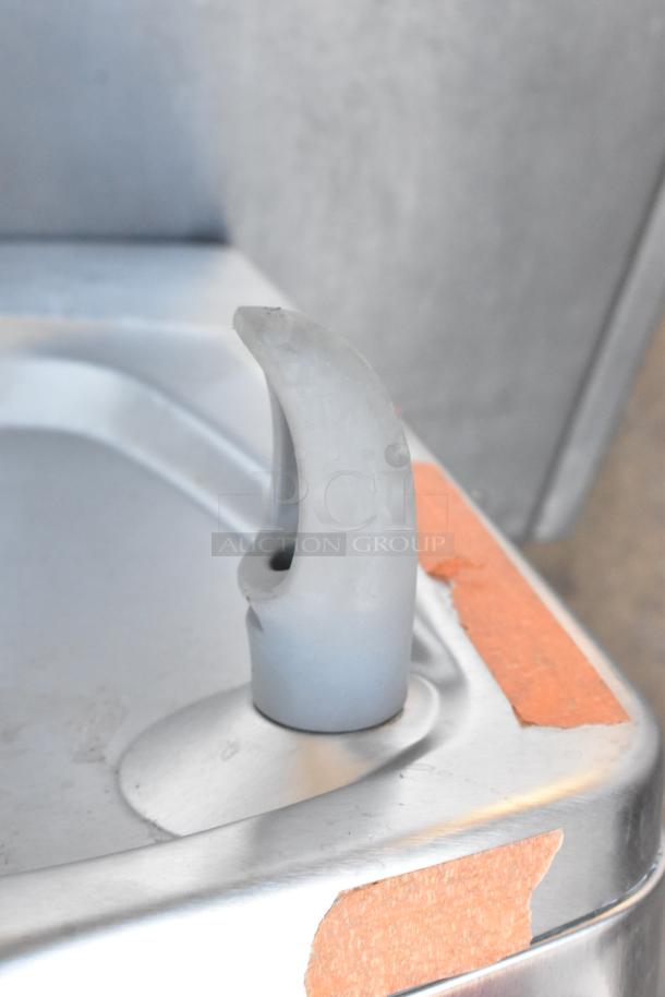 BRAND NEW Oasis PWEBF-005 stainless steel wall mount water fountain, scratch and dent condition, visible tape repairs.