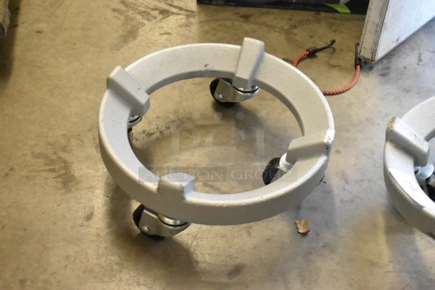 Brand new metal bowl dolly on commercial casters, with minor scratches and dents. Durable design for industrial use.