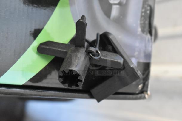 Out of focus image showing a part of a box labeled "BRAND NEW SCRATCH AND DENT" for an AvaMix 928IBMD10 immersion blender.