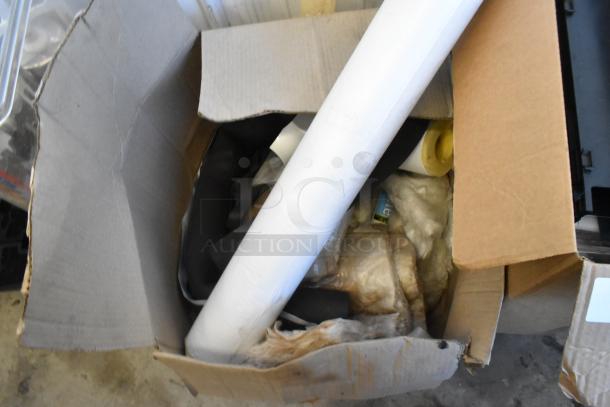 Lot of 2 cardboard boxes with various items including poly drink sliders, mixed condition. Contents partially visible.