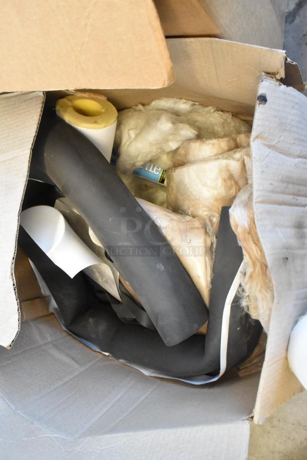 Lot of miscellaneous items in open box, including poly drink sliders, foam, and insulation materials. Mixed condition.