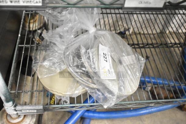 Set of 4 metal food processor blades in plastic bag; 2 slicing, 2 grating. Auction label indicates "227, 4 times your bid."