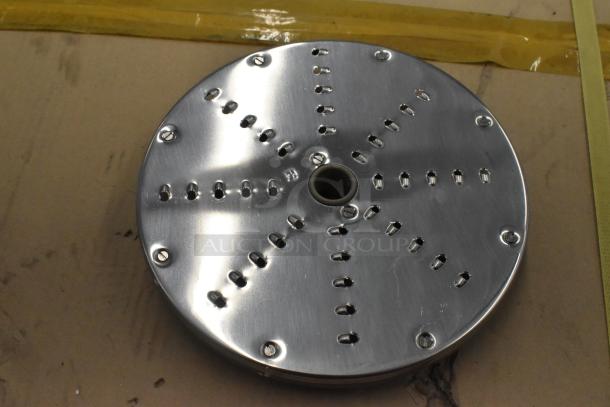 Set of 4 metal food processor blades; includes 2 slicing and 2 grating blades. Shiny metal finish, used condition.