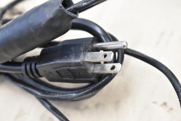 Close-up of the power cord plug for the Cooking Performance Group 351SMKR120 Portable Smoker Box, 120 Volts.