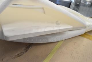 Two pristine cooking stones, packaged in foam, perfect for even heat distribution in baking or grilling.