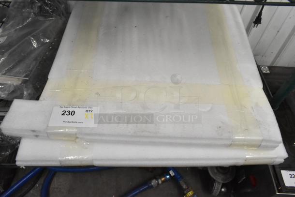 Two white cooking stones stacked, taped together. Auction label shows item number 230, quantity 2.