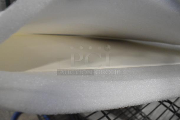 Two cooking stones wrapped in protective foam, appearing new and unused.