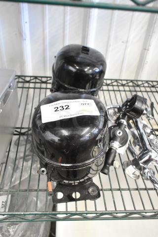 Two Cubigel NUT90LR compressors, 115-127V, 1 phase, black finish, stored on a shelf, labeled QTY 2, item 232.
