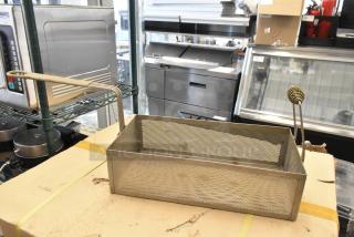 Two metal fry baskets, rectangular, with elongated handles, perforated sides, in used condition, ideal for commercial kitchens.
