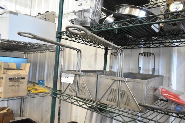 Two metal fry baskets with long handles on a wire shelf. Good condition, ideal for deep frying. Auction tag shows "234".