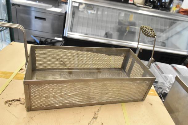 Two rectangular metal fry baskets with perforated sides and wire handles. Featuring sturdy construction and slightly used condition.