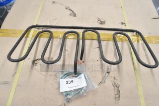Metal burner with coiled design, new condition. Includes a bag with label "235" for auction identification.